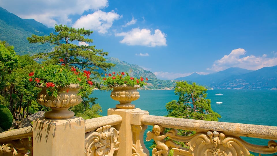 A scenic view of a coastal area with mountains, a clear sky, and a body of water.