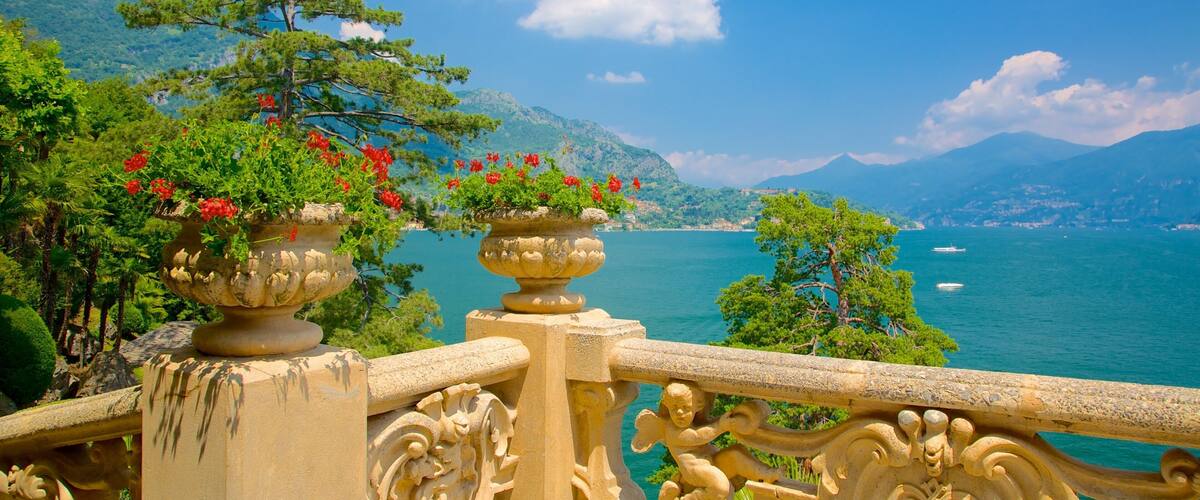 A scenic view of a coastal area with mountains, a clear sky, and a body of water.