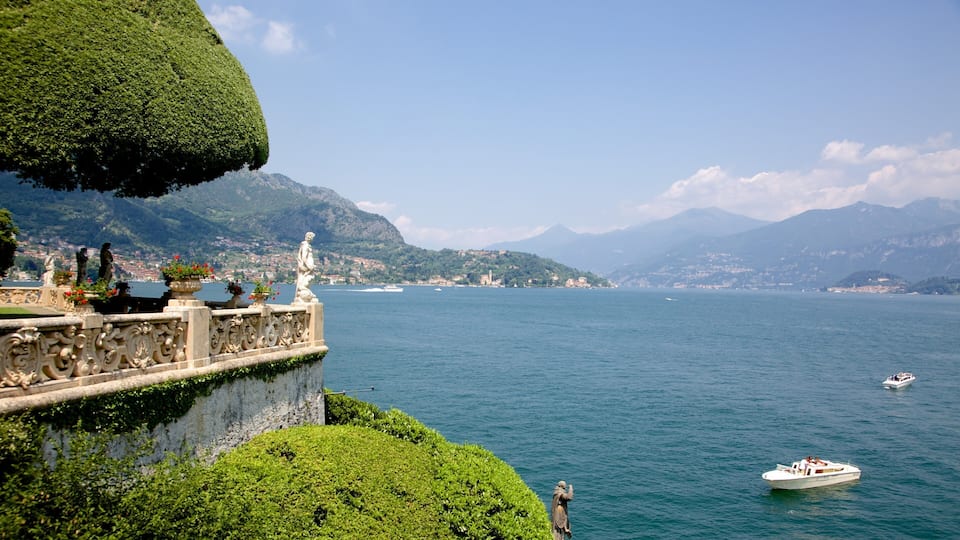 A scenic lake with a stone balustrade, statues, and boats.
