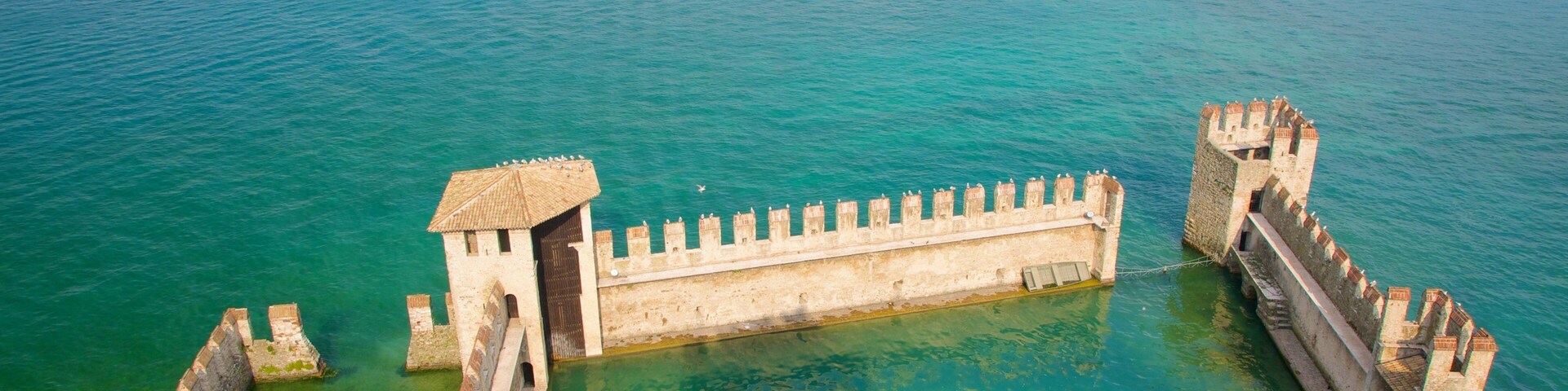 Scaliger Castle showing a lake or waterhole and building ruins