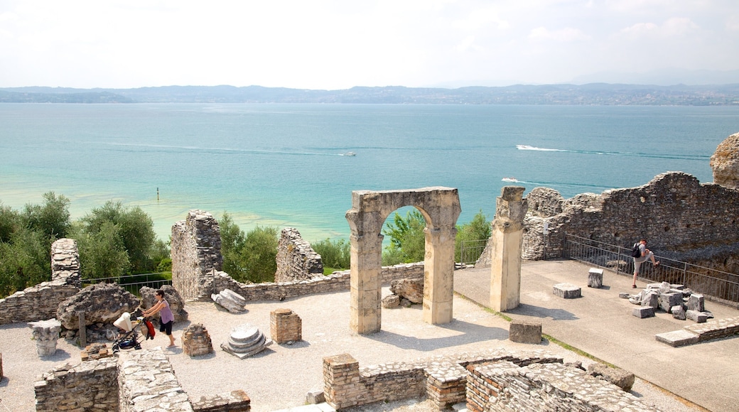 Grotto of Catullus which includes a ruin, general coastal views and heritage elements