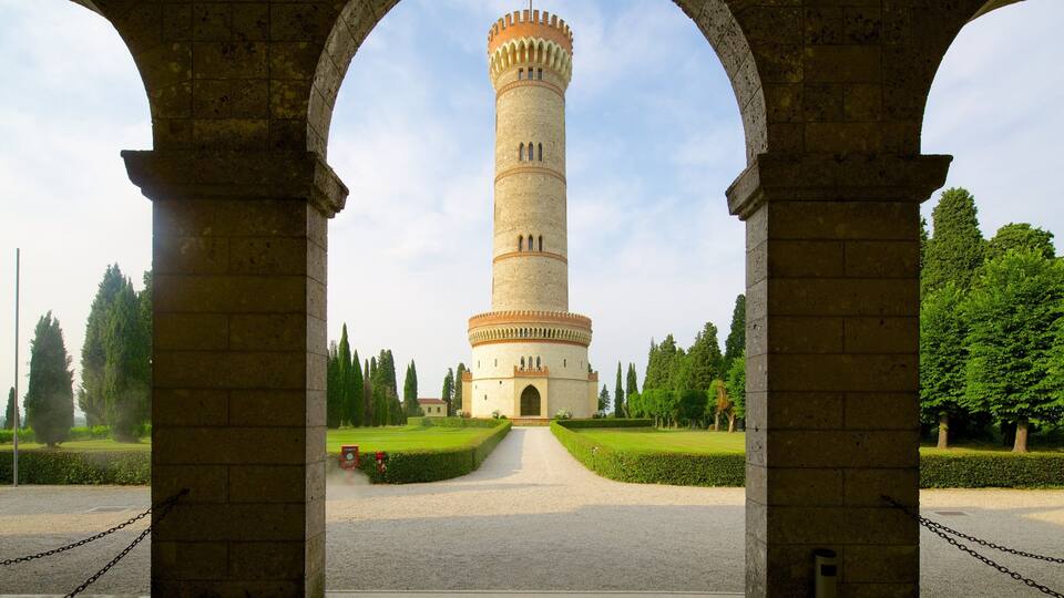 A historic tower with a central arched entrance framed by stone columns.