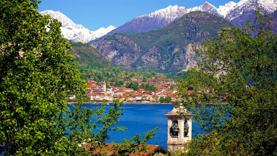 A town by a lake with mountains in the background.