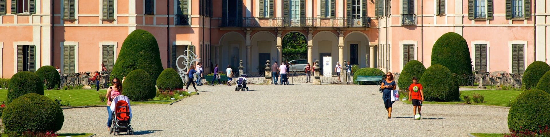 Estense Palace featuring chateau or palace as well as a large group of people