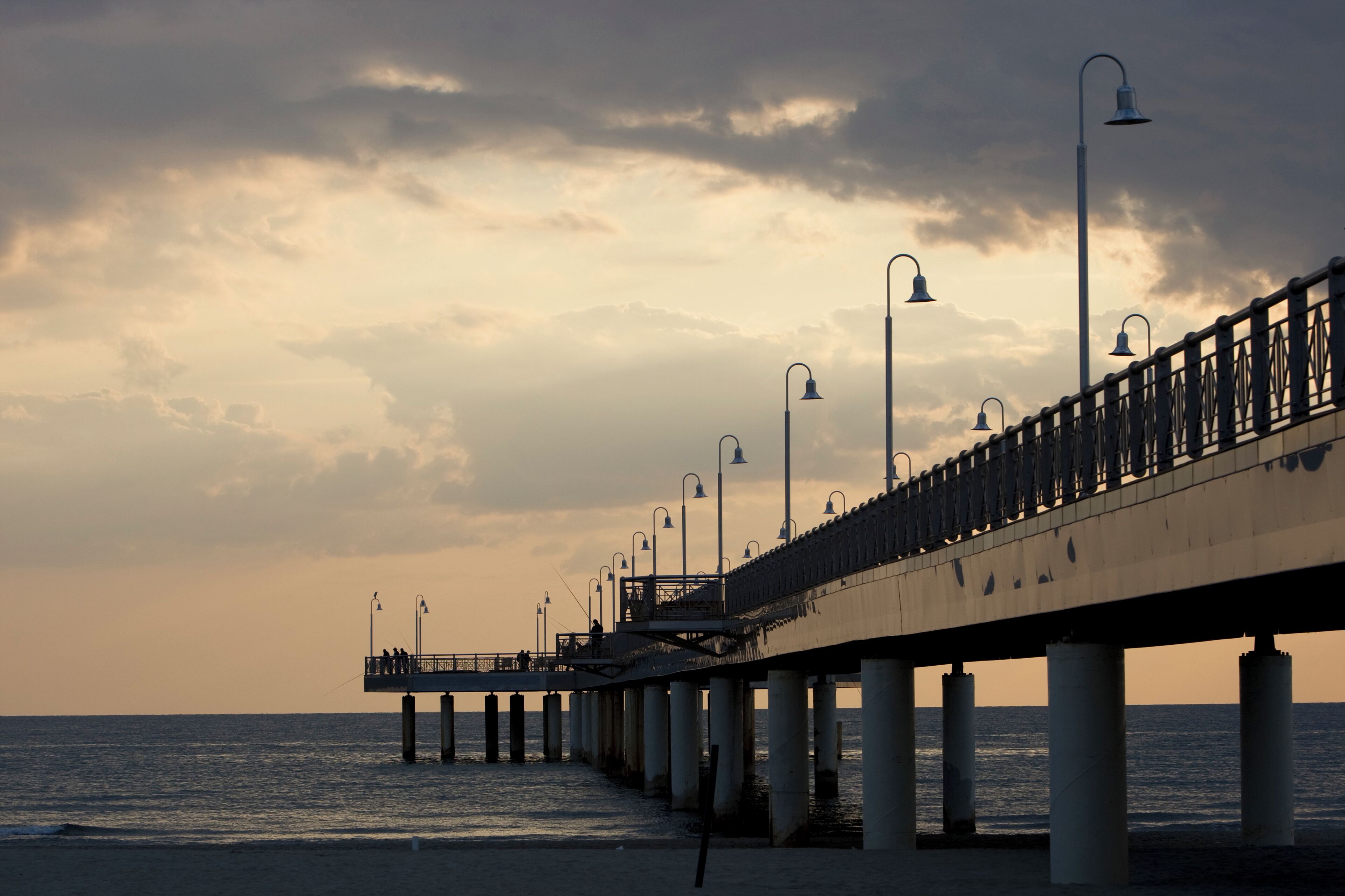 Italy, Tuscany, Forte dei Marmi, Pier and cloudy sky