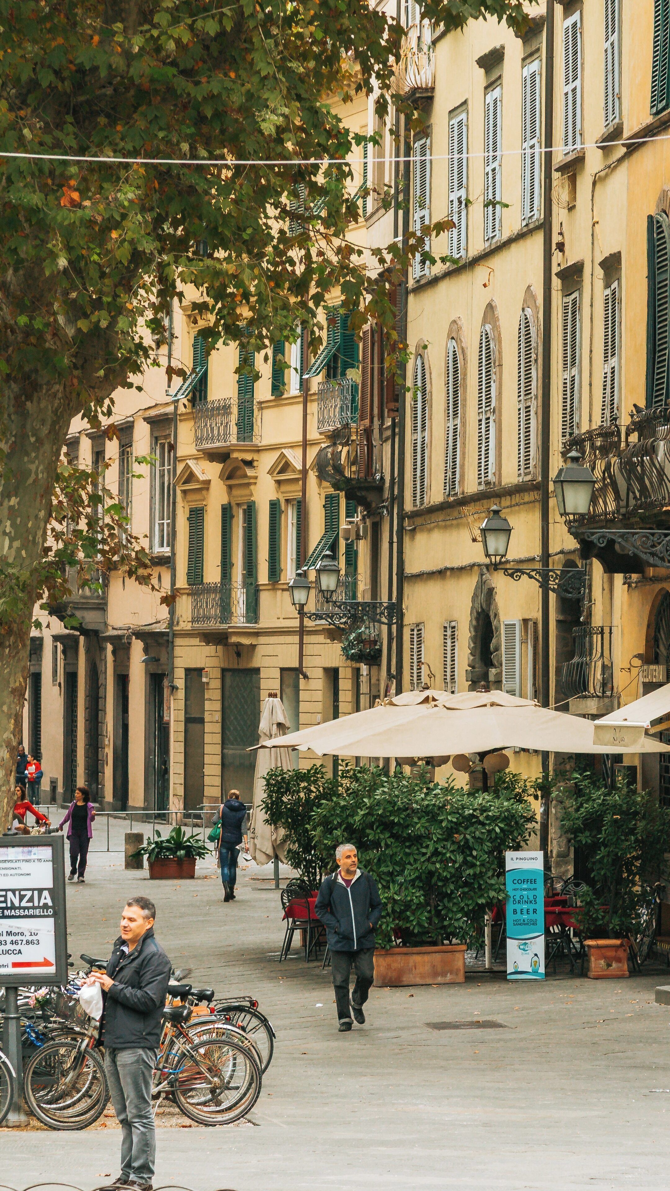 Exploring Piazza Napoleone in Lucca, a beautiful historic center in Tuscany with lively atmosphere and charming architecture