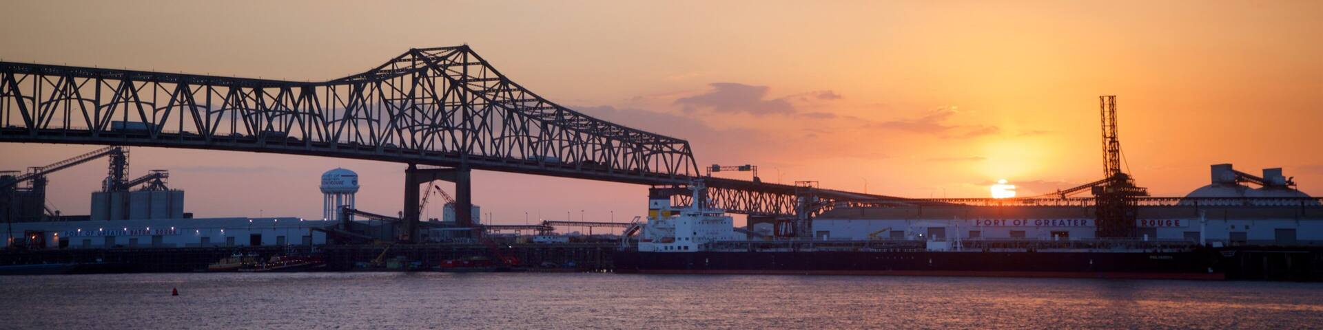 Howard Wilkinson Bridge showing a river or creek, a sunset and a bridge