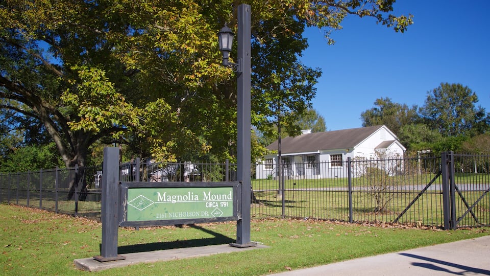 Magnolia Mound Plantation House showing a park and signage