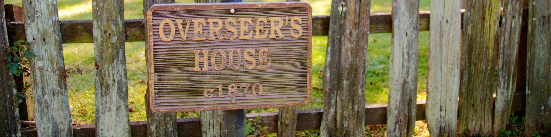 Magnolia Mound Plantation House featuring signage, a house and heritage elements
