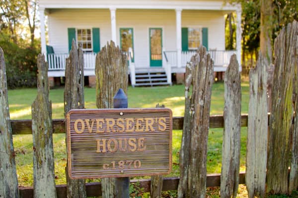 Magnolia Mound Plantation House featuring heritage elements, signage and a house