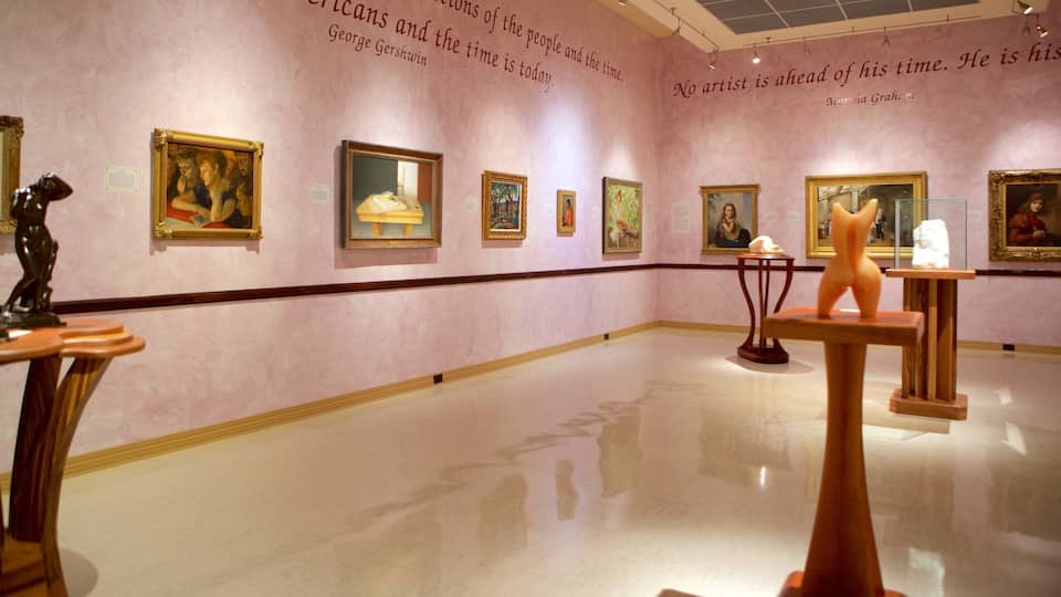 An art gallery with paintings on the walls and sculptures on pedestals.