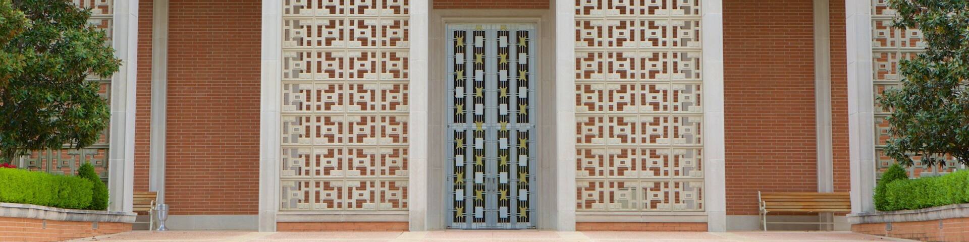 The PW Norton Art Gallery with a central entrance flanked by decorative screens and brick columns.