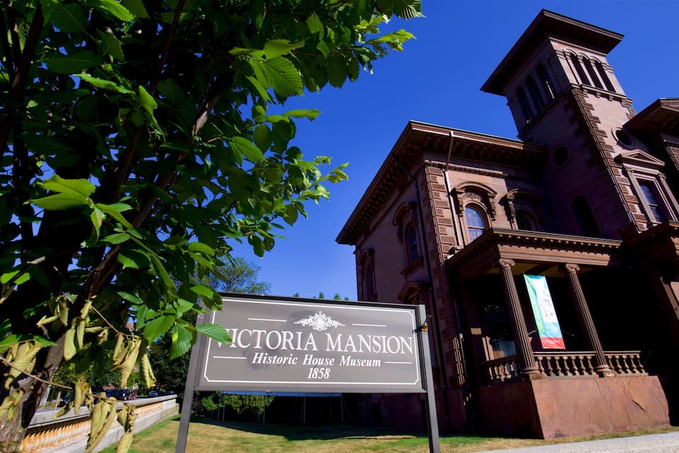 The Victoria Mansion Historic House Museum with a clear blue sky in the background.