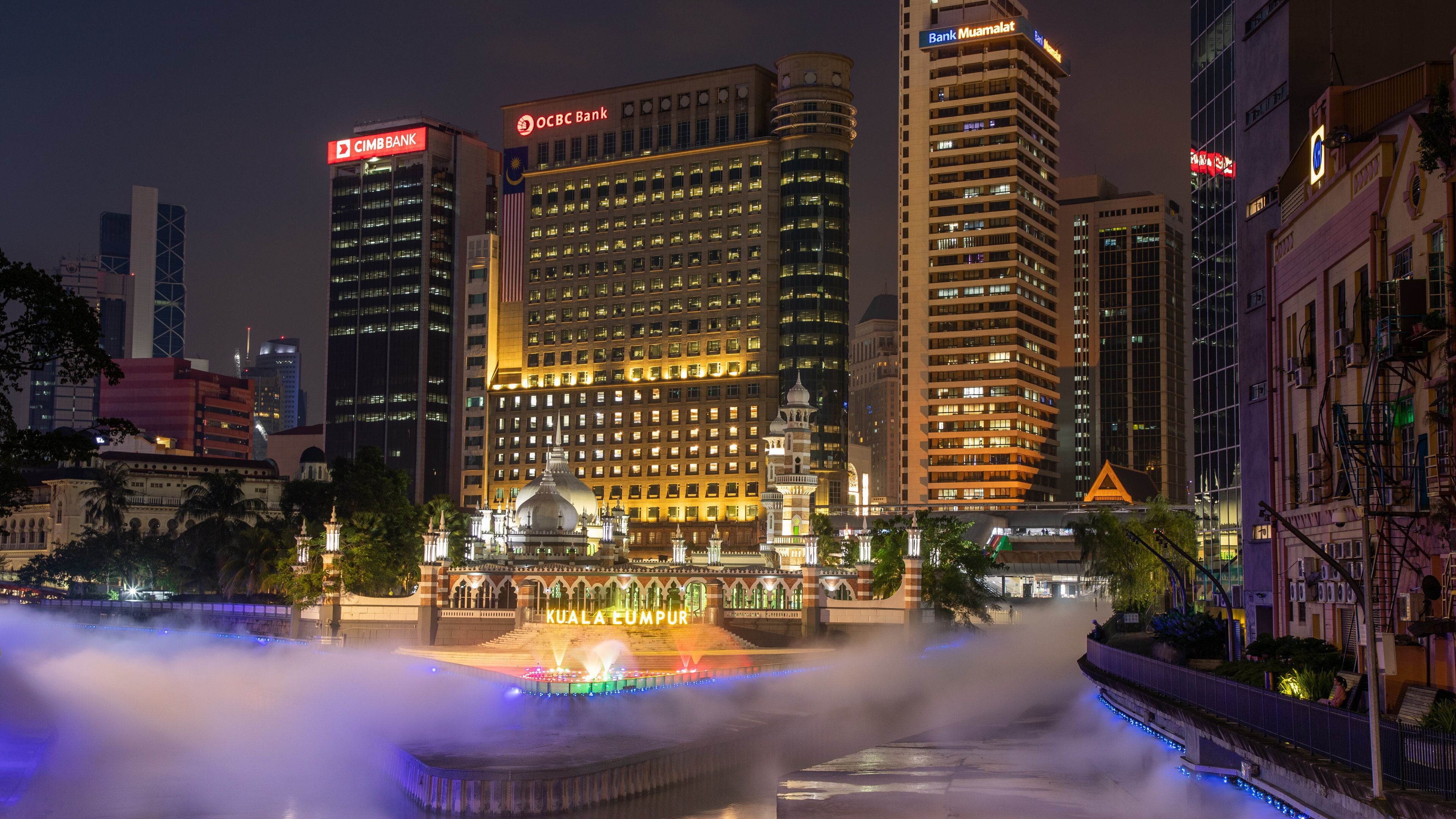 Jamek Mosque showing a river or creek, mist or fog and night scenes