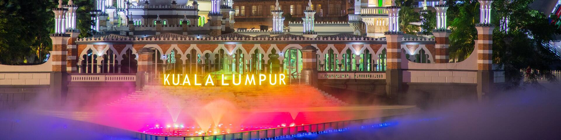 Jamek Mosque showing mist or fog, heritage architecture and a city