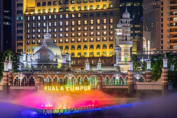 Jamek Mosque showing mist or fog, heritage architecture and a city