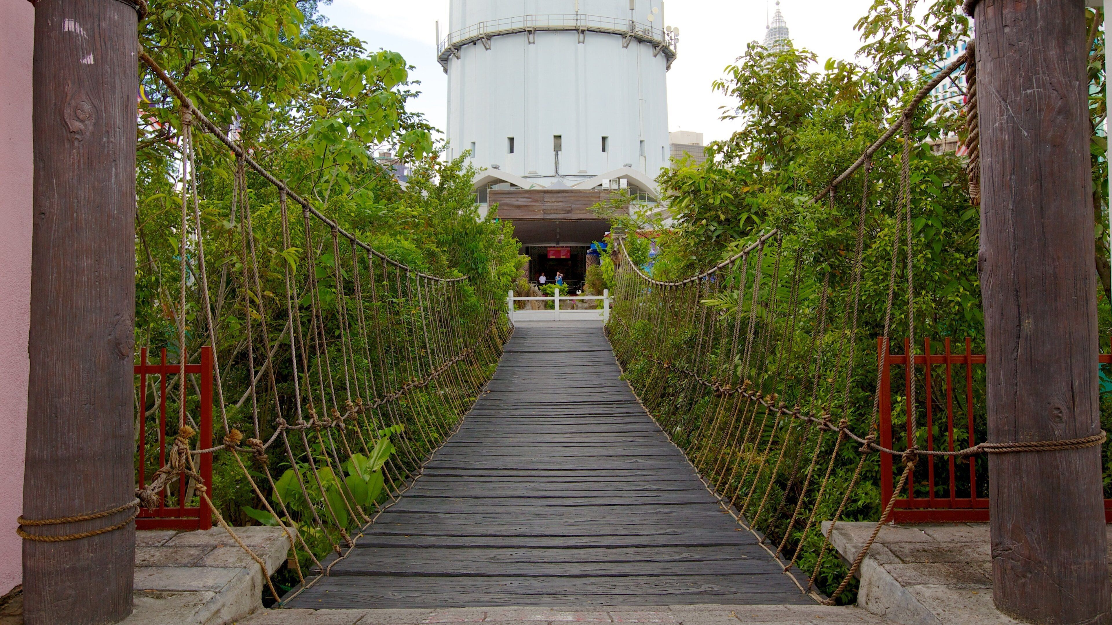 Kuala Lumpur Tower featuring a garden and a suspension bridge or treetop walkway