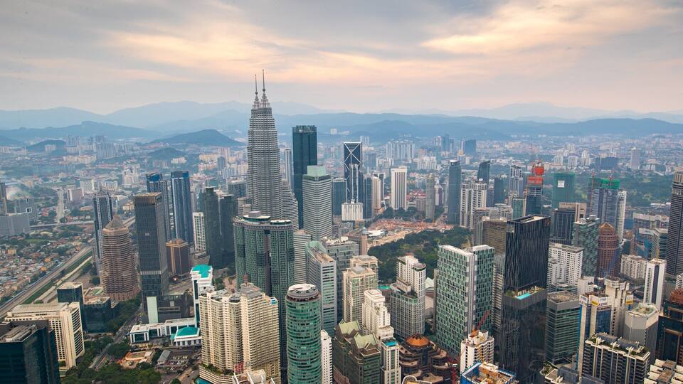 A cityscape with numerous high-rise buildings, including a distinctive skyscraper with a unique design.
