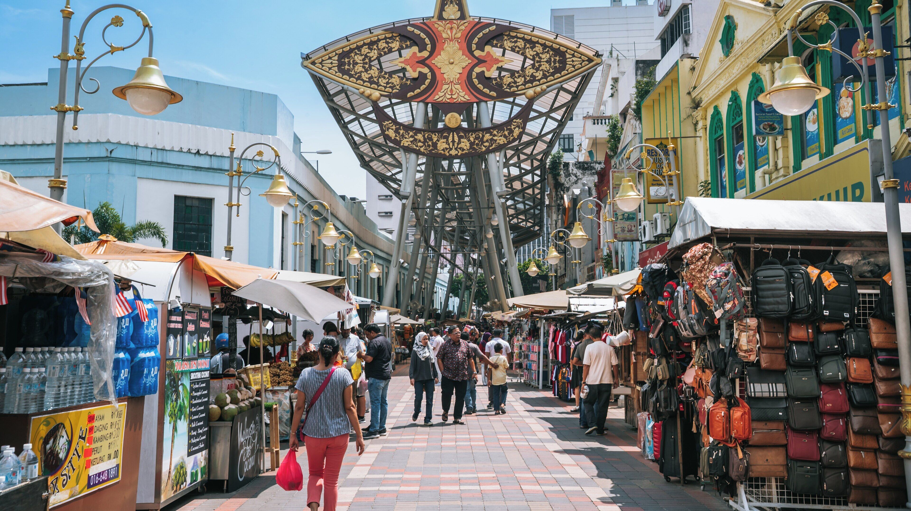 Vibrant atmosphere of Central Market in Chinatown Kuala Lumpur bustling with visitors and local vendors on a sunny day