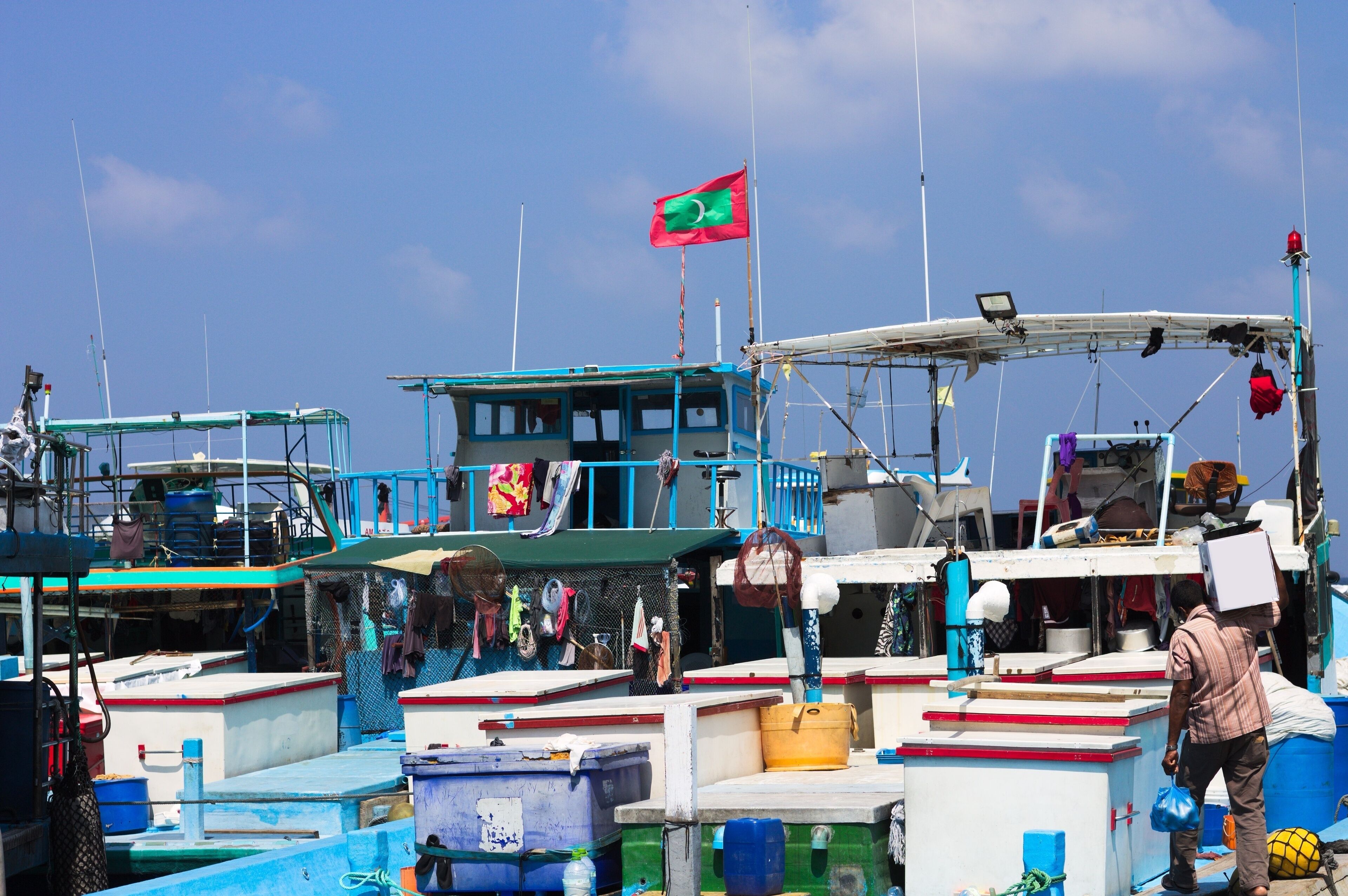 Maldivian flag over the harbor in Male fish market (Maldives, Asia)