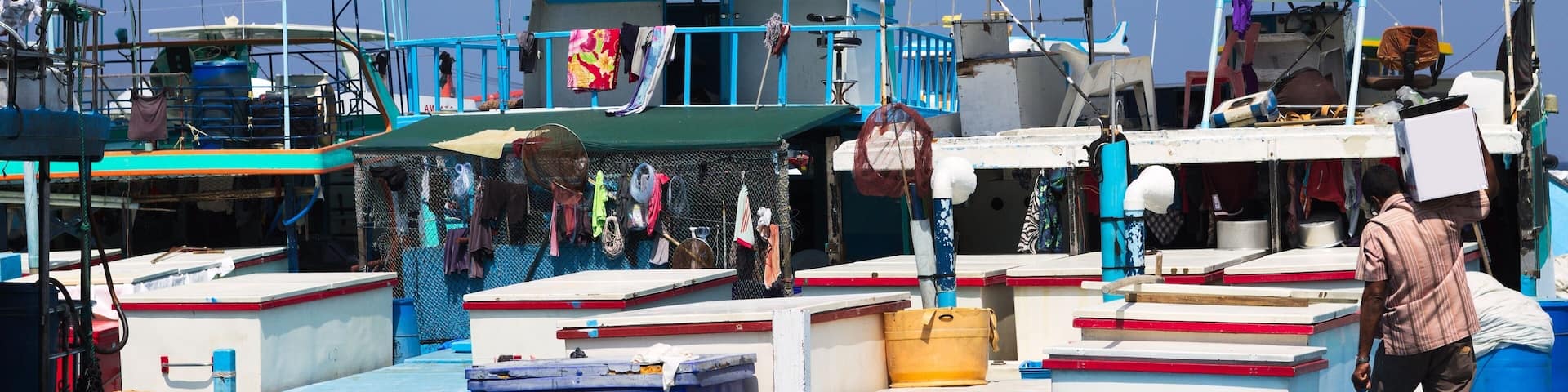 Maldivian flag over the harbor in Male fish market (Maldives, Asia)