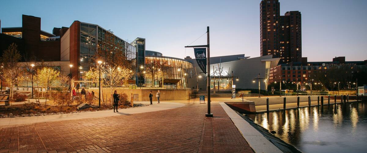 Maryland Science Center which includes a bay or harbor, night scenes and a sunset