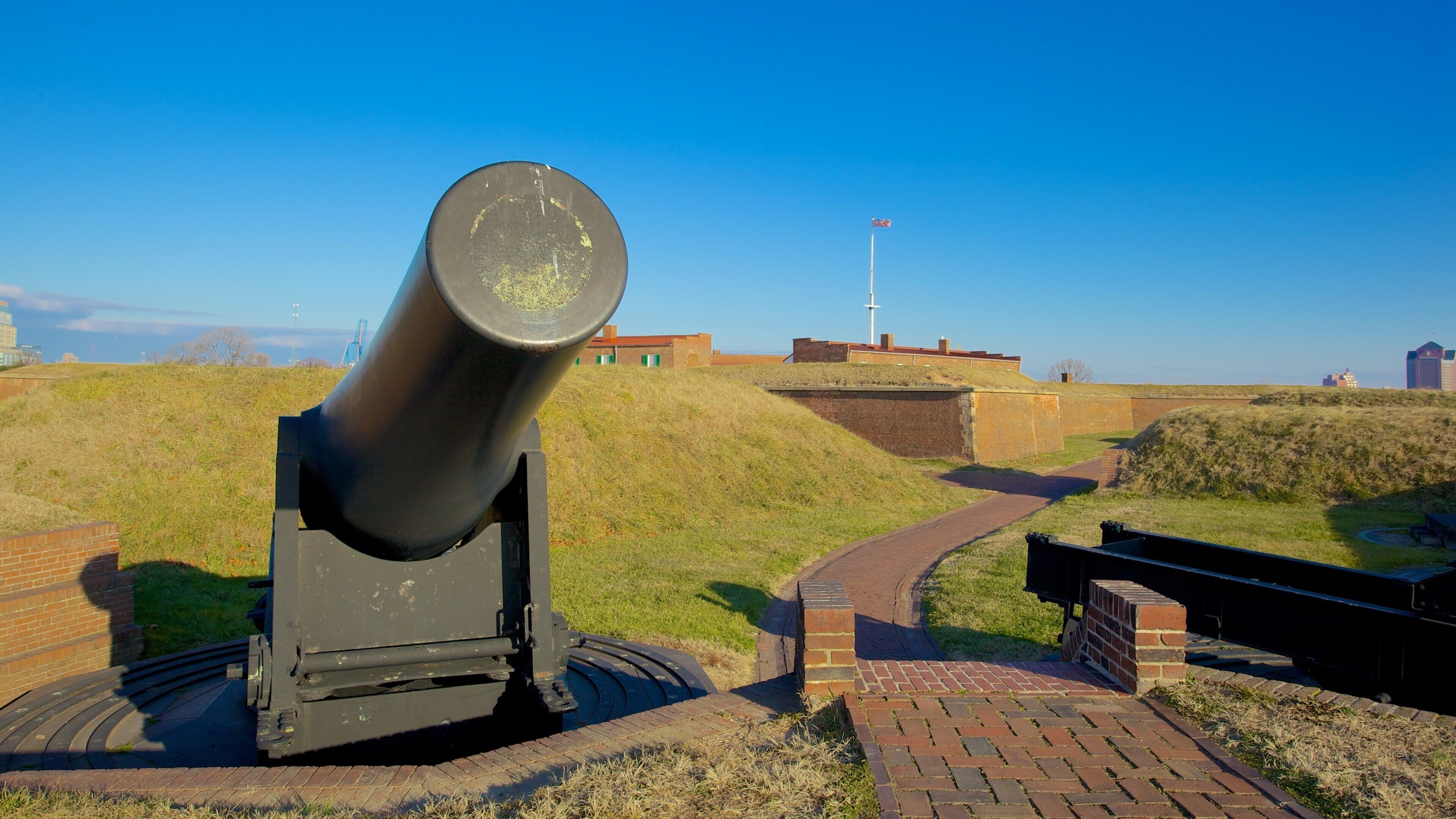 Fort McHenry showing military items and a monument