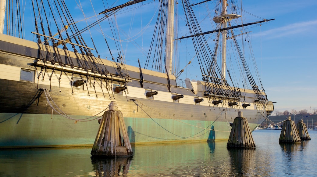 Historic USS Constellation docked in Baltimore, Maryland on a clear sunny day with calm waters and visible masts
