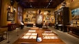 A museum with wooden display cases, paintings, and a large globe.
