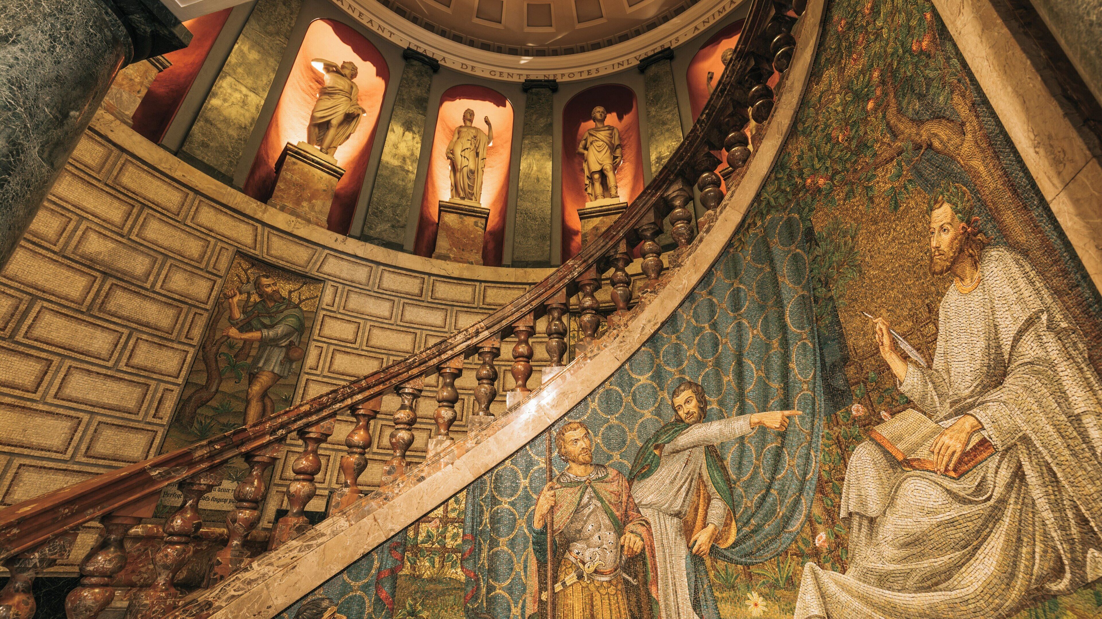 Exploring the stunning interior of Biblioteca Ambrosiana featuring intricate mosaics and classic sculptures in Milan, Lombardy, Italy