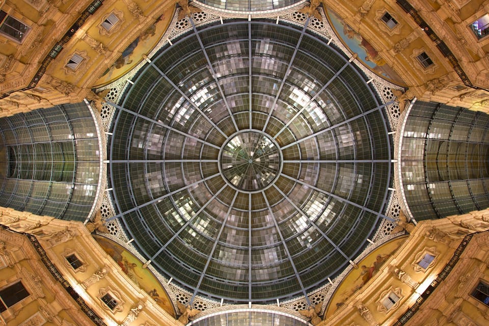 A grand, ornate building with a large circular glass dome and intricate architectural details.