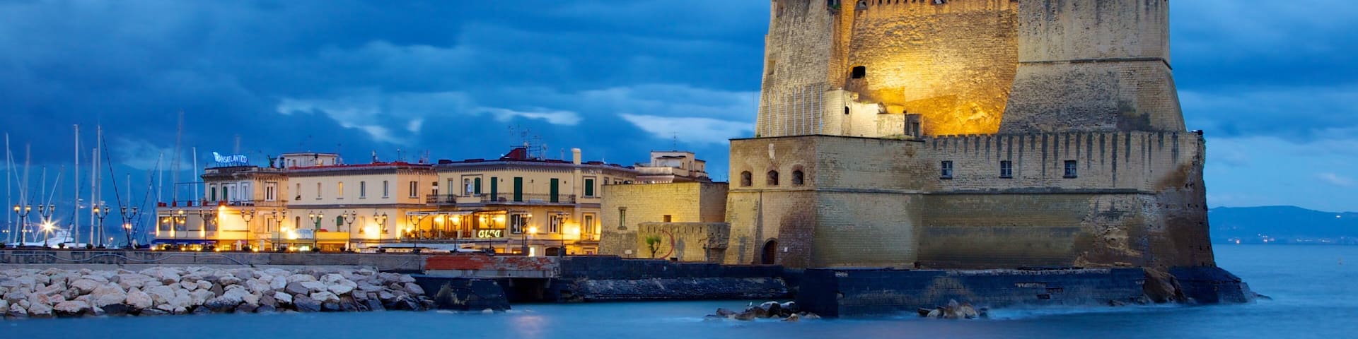 Castel dell\'Ovo which includes night scenes, general coastal views and chateau or palace