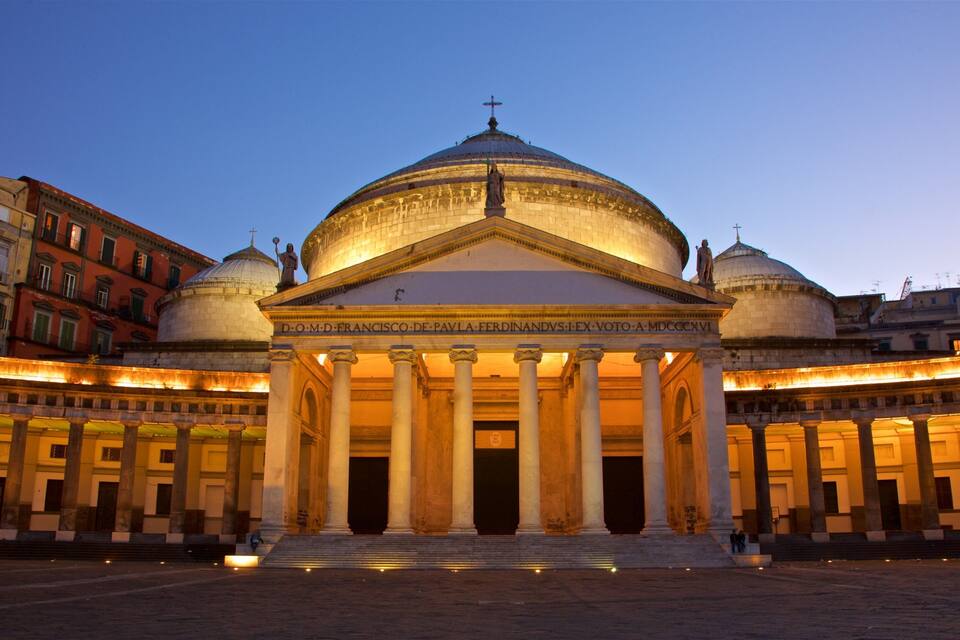 A grand neoclassical building with a large dome and columns, surrounded by historic buildings.