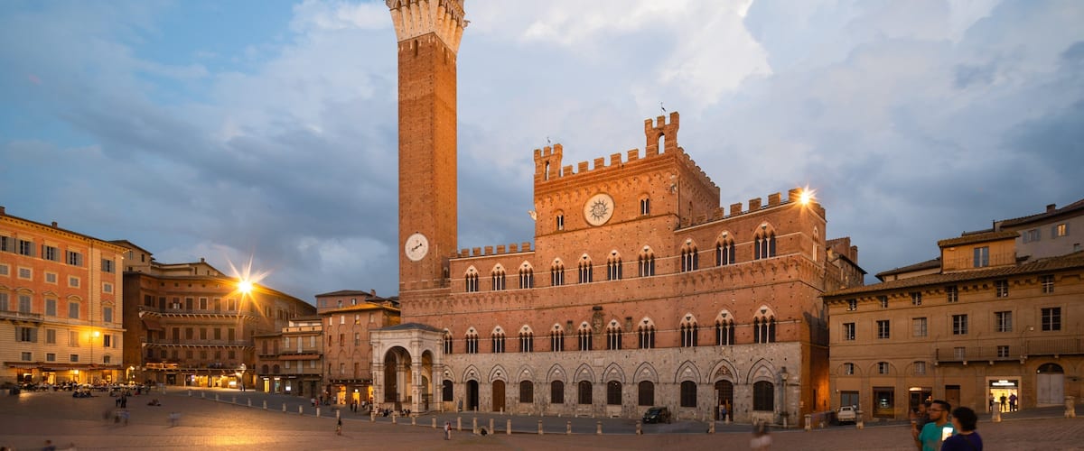 Palazzo Pubblico featuring a city, heritage architecture and night scenes