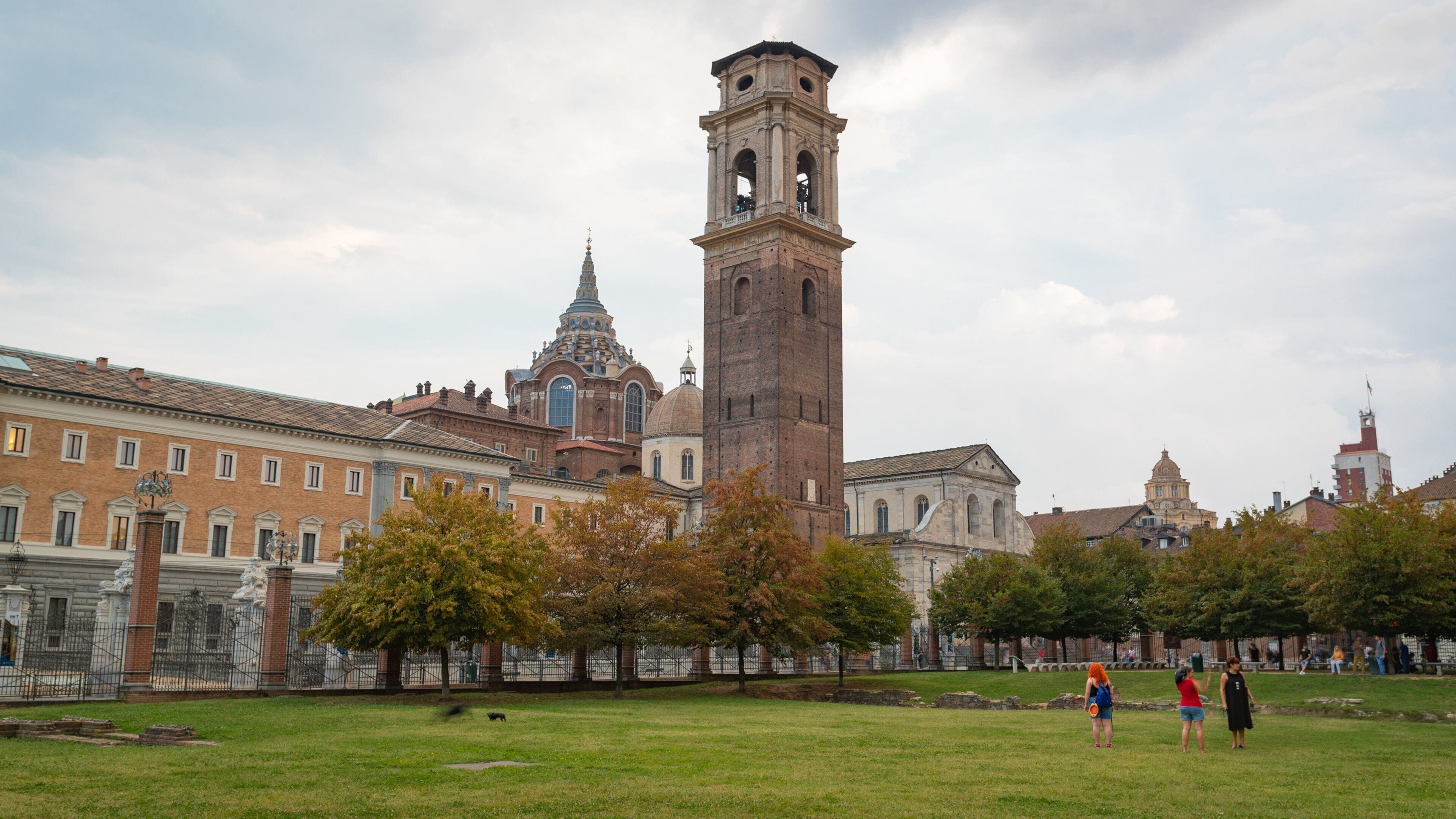 Turin Cathedral showing a garden and heritage elements as well as a small group of people