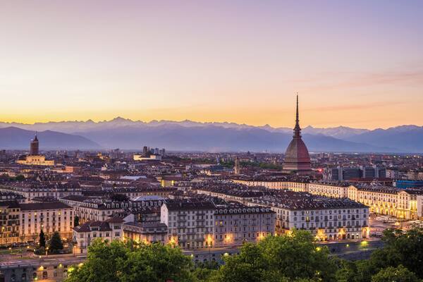 Cityscape of Torino (Turin, Italy) at sunsetwith colorful clear sky. The Mole Antonelliana towering on the city.