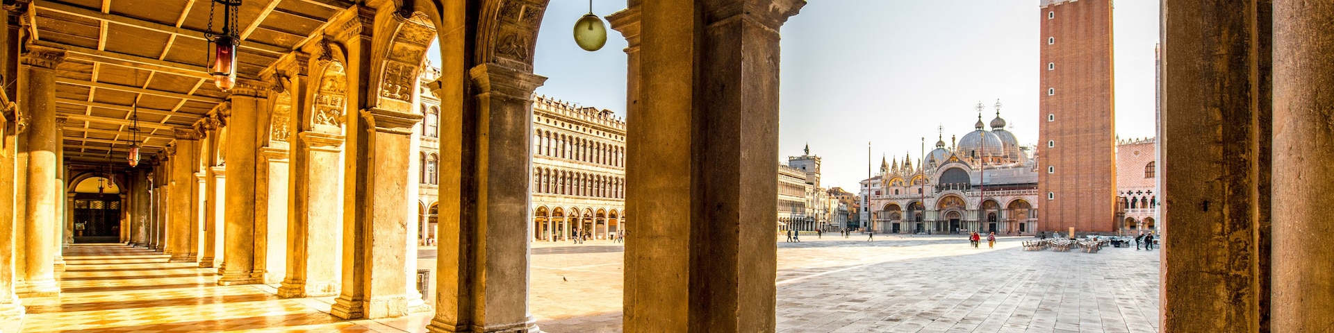 Arches of Correr museum with San Marco tower on the main square in the morning in Venice