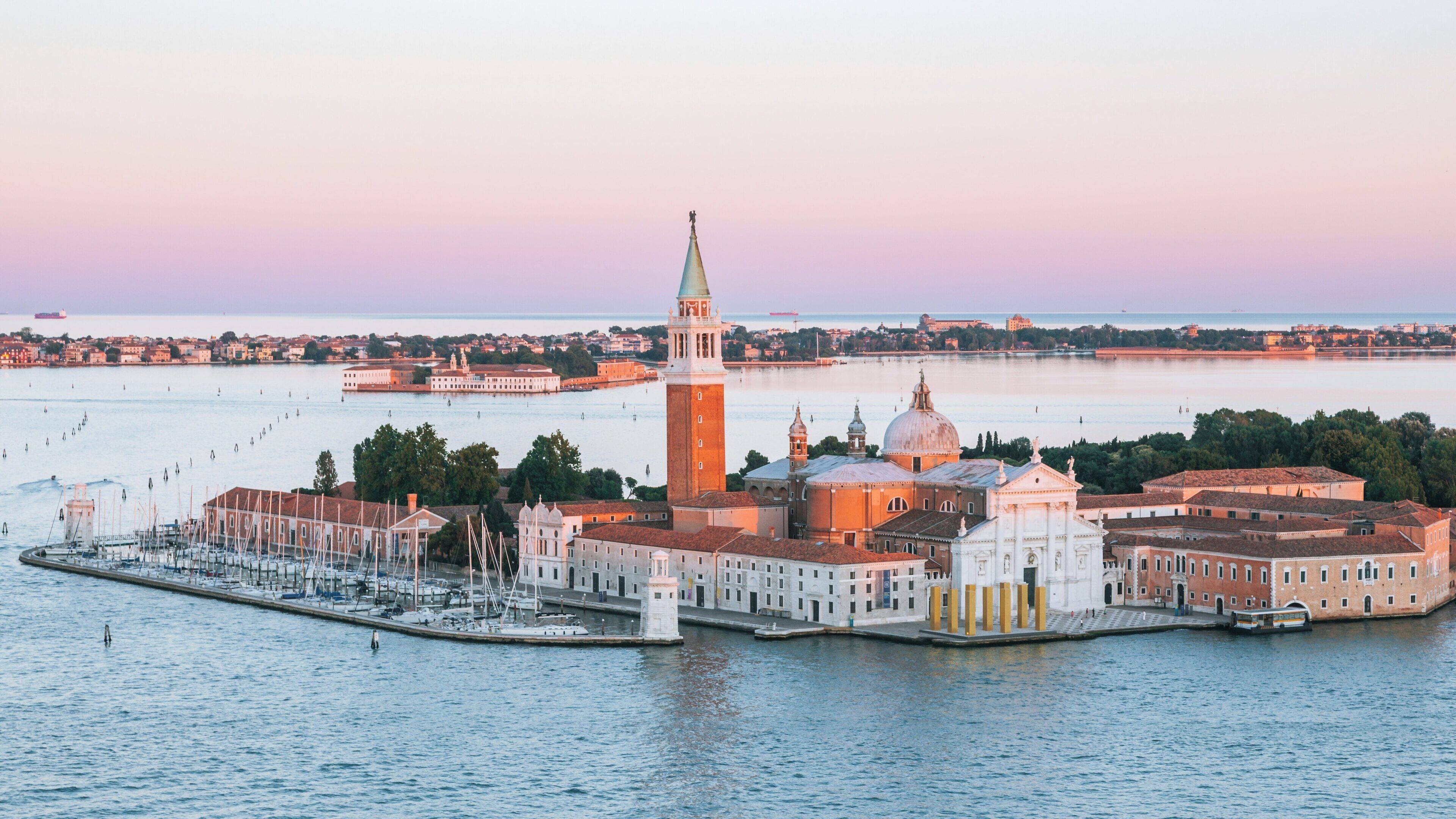 St Mark's Campanile stands tall in Venice's vibrant city center with stunning views of the lagoon at dusk