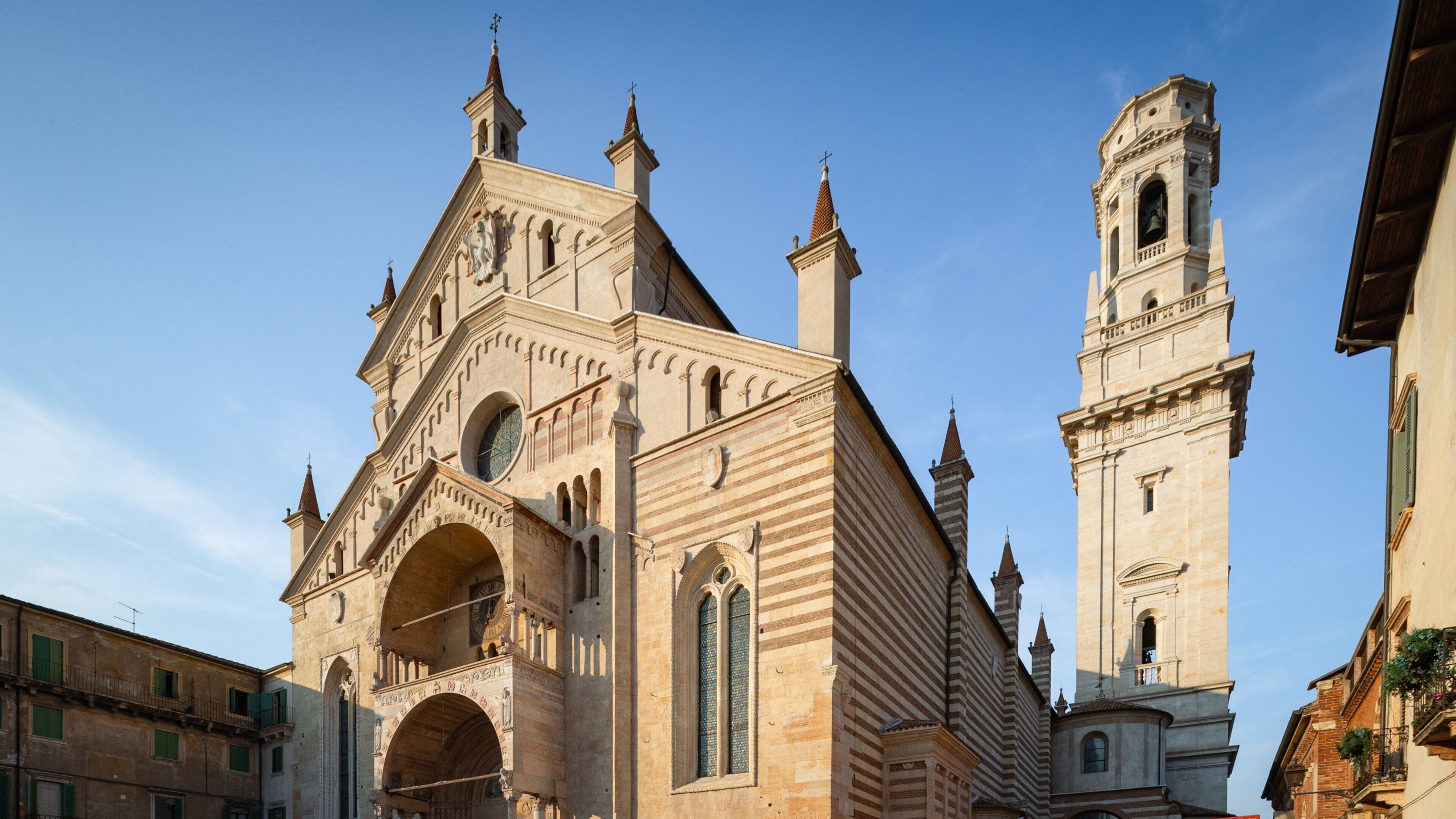 A historic church with a prominent bell tower and arched windows.
