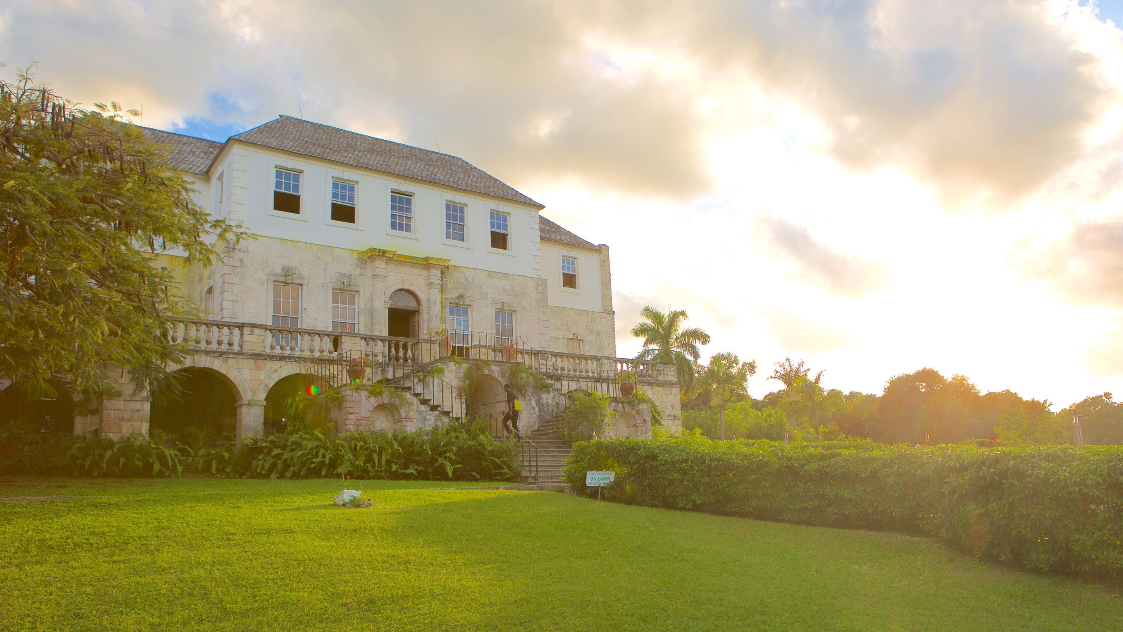 Rose Hall Great House featuring a sunset, heritage architecture and a garden