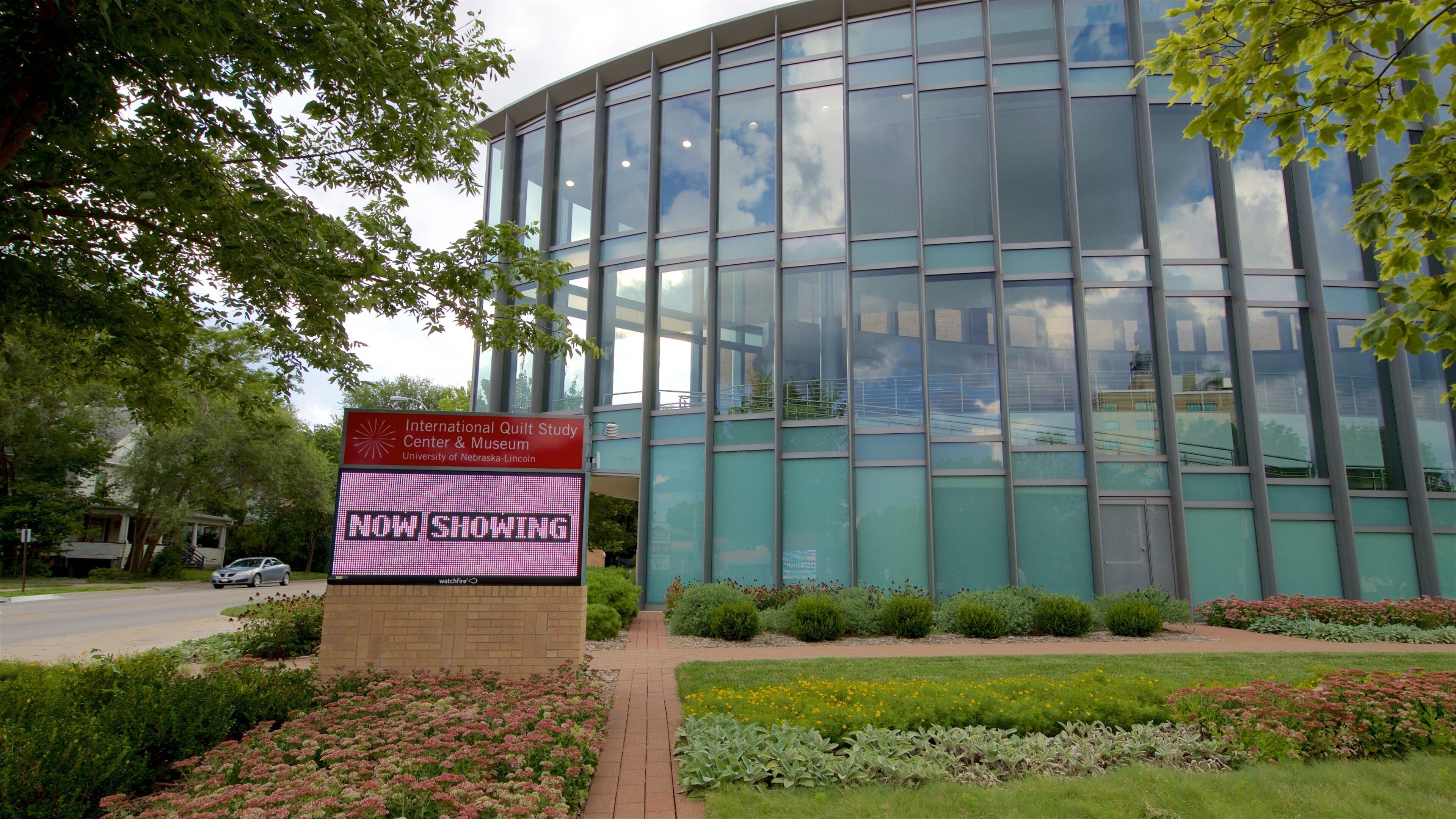 International Quilt Study Center showing a garden, signage and flowers