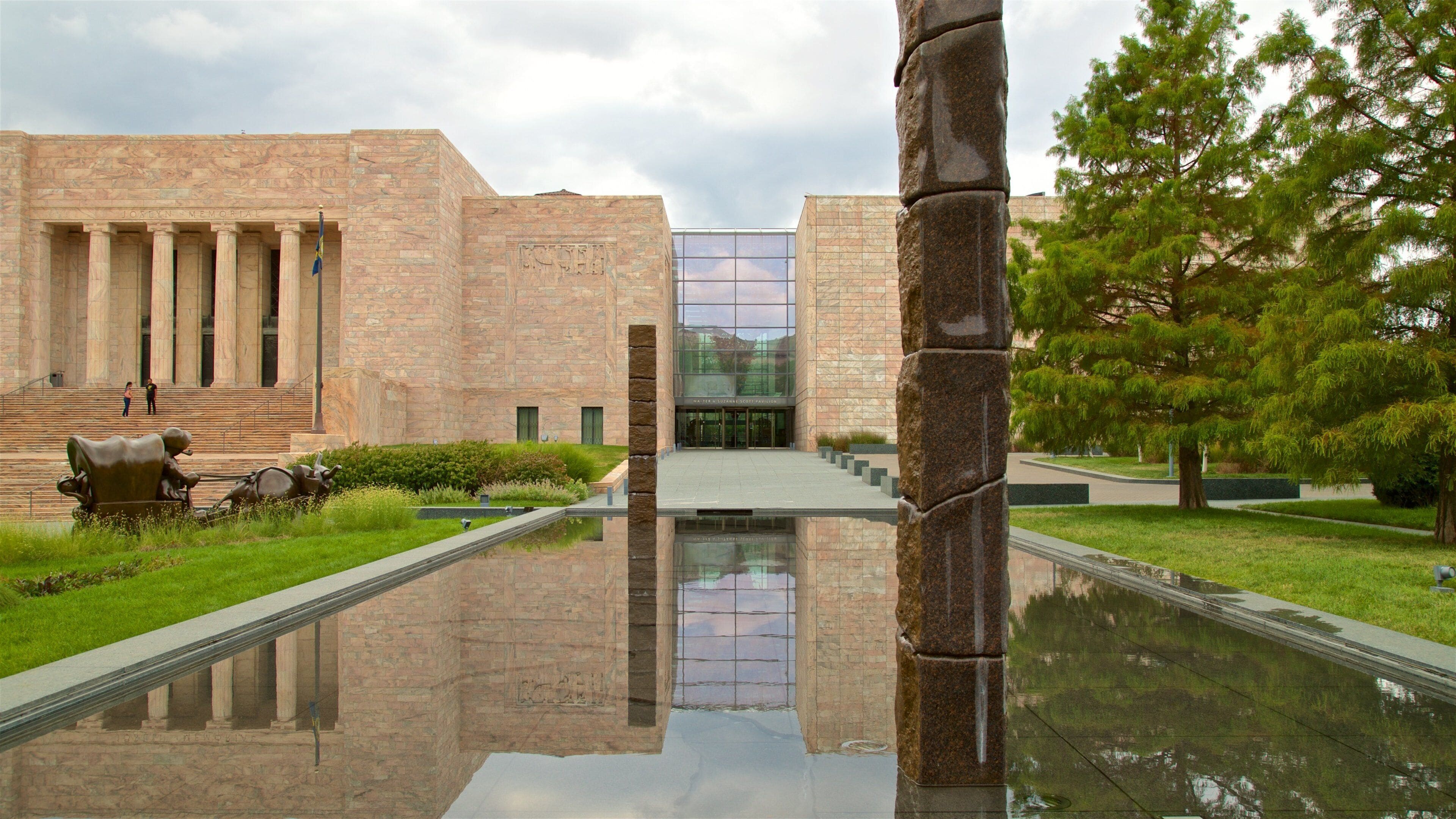Joslyn Art Museum which includes a garden, a pond and outdoor art