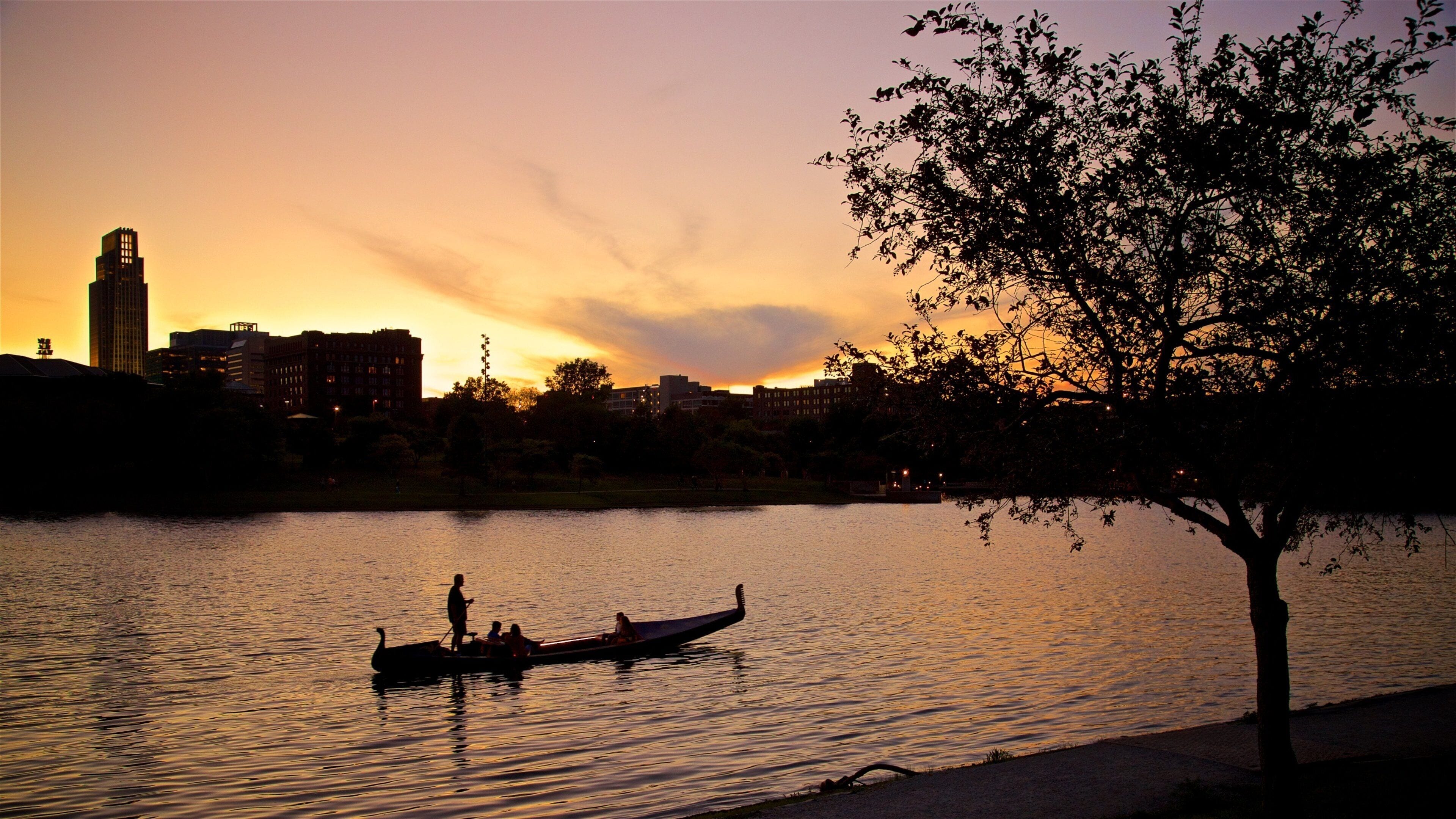 Heartland of America Park which includes a river or creek, kayaking or canoeing and a sunset