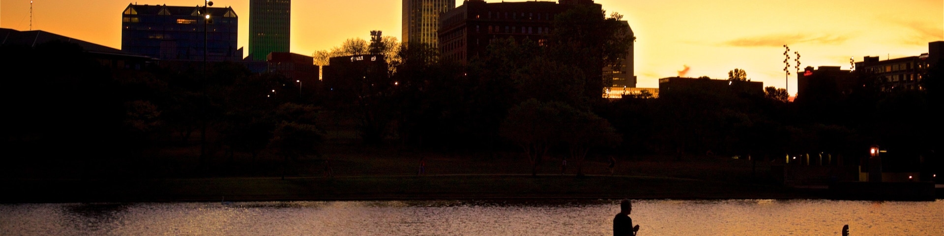 Heartland of America Park showing a sunset, skyline and kayaking or canoeing