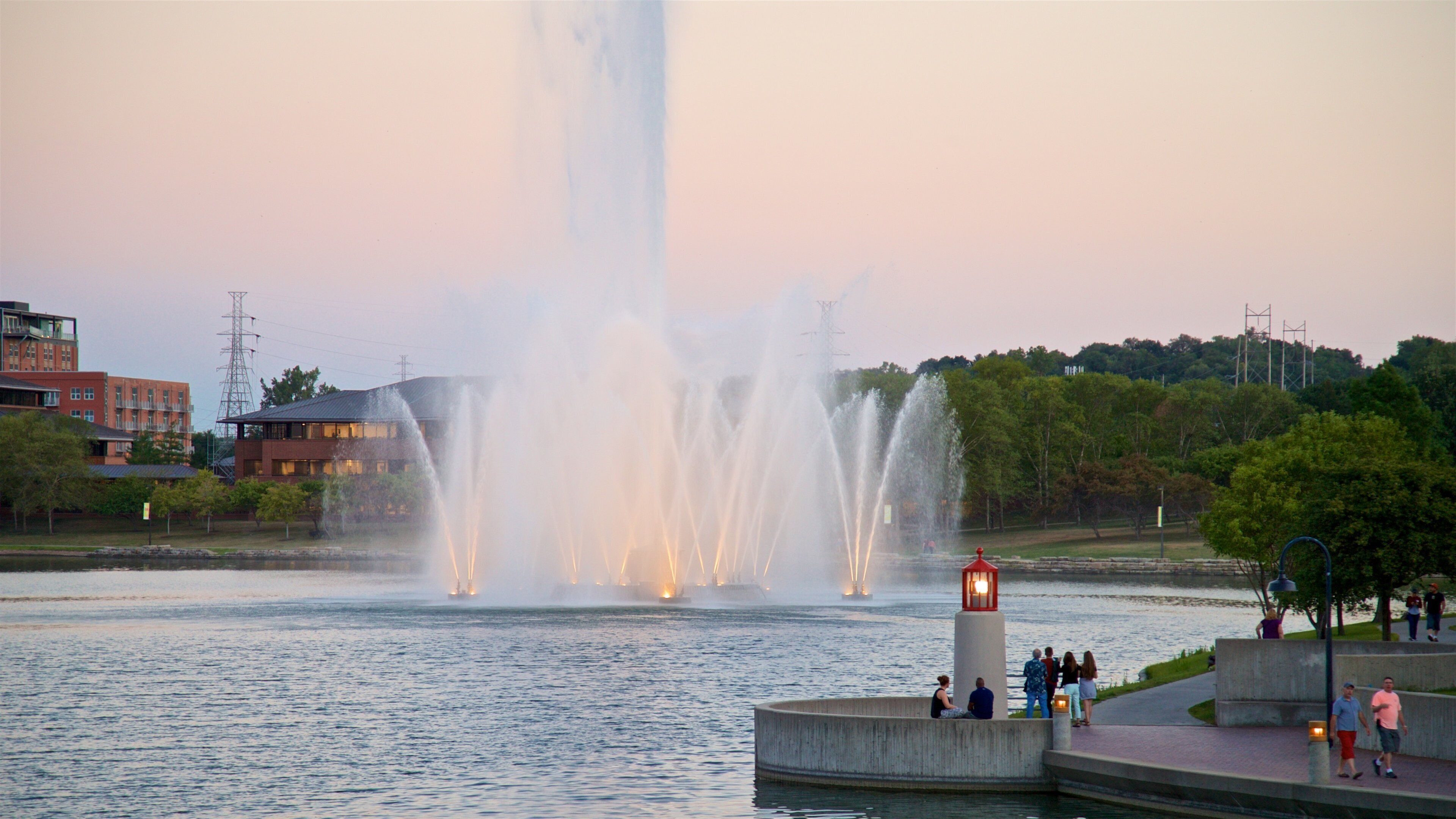 Heartland of America Park which includes a fountain, a lake or waterhole and a sunset