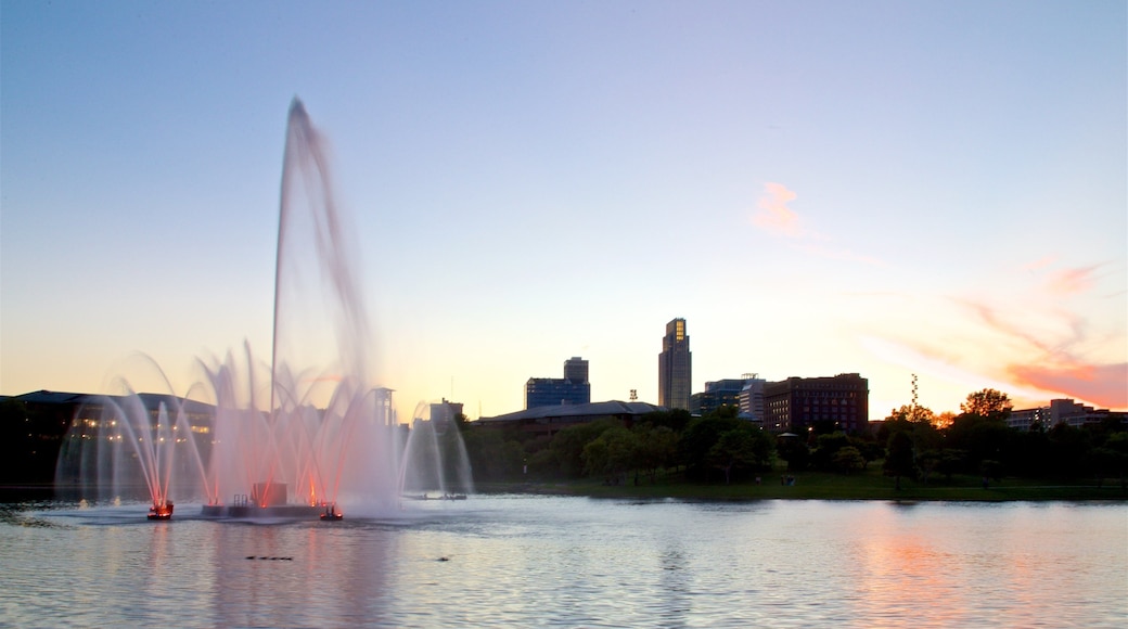 Heartland of America Park which includes a fountain, a sunset and a lake or waterhole