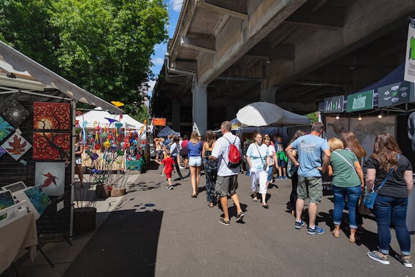 Portland Saturday Market showing markets as well as a small group of people