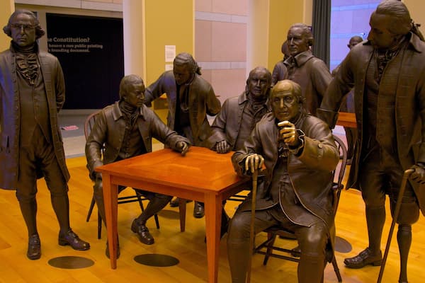 Statues of founding fathers discussing the Constitution at National Constitution Center in Philadelphia