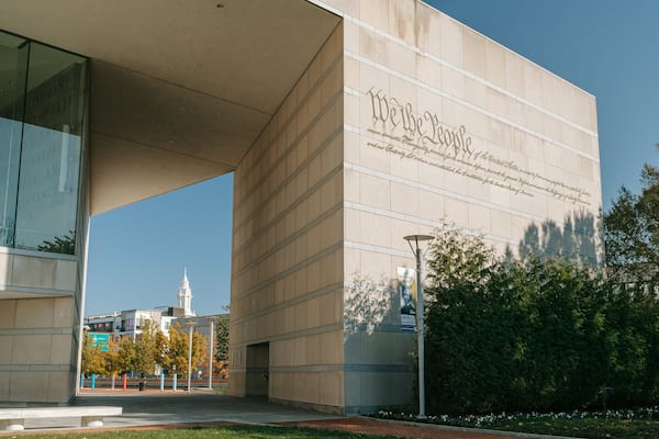 A modern building with a large inscription on its facade.