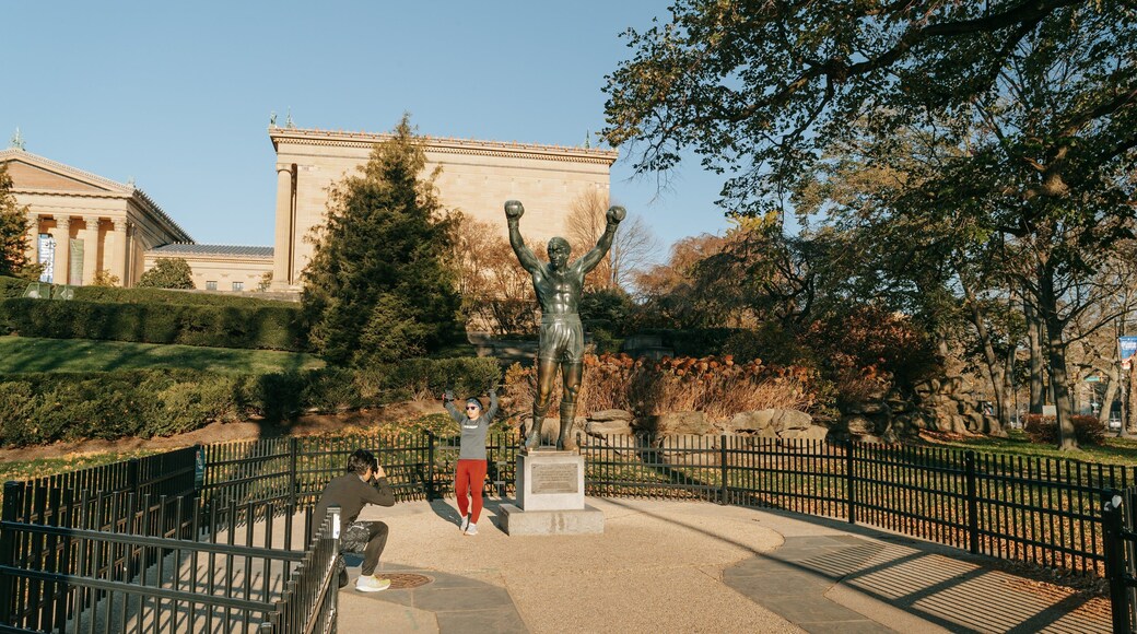 Rocky Statue showing a statue or sculpture as well as a couple